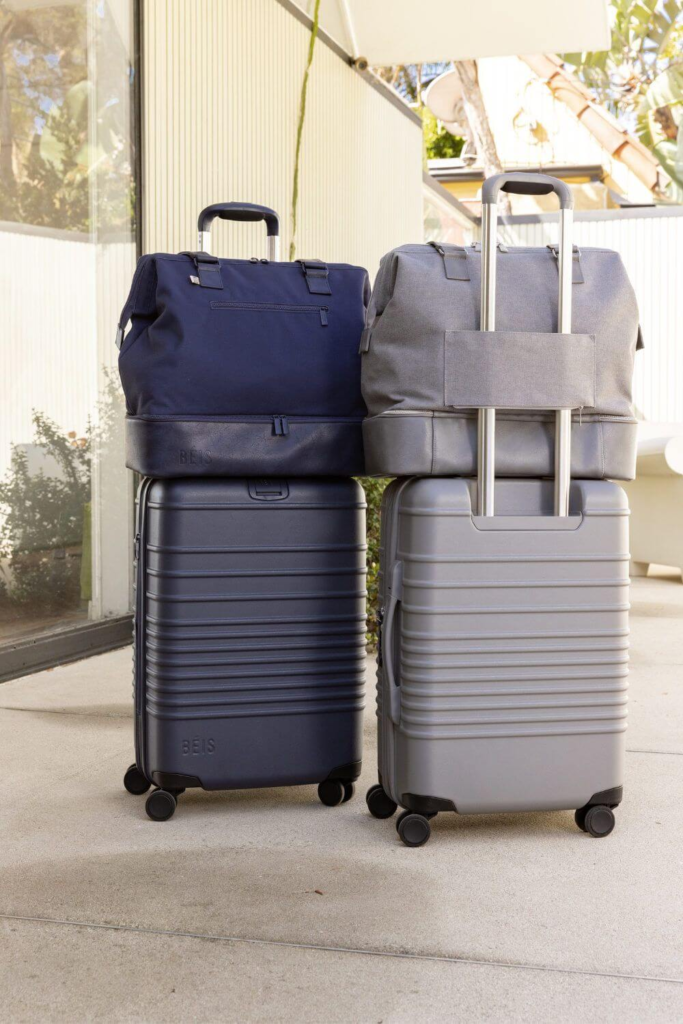 Two carry-on suitcases with matching travel bags stacked on top