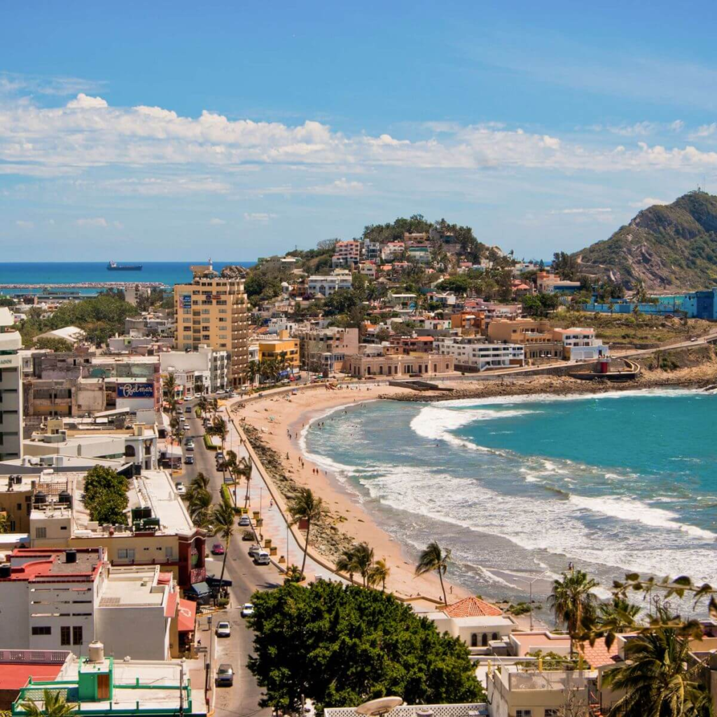 Aerial view of Mazatlán Mexico with beachfront, buildings, and turquoise water