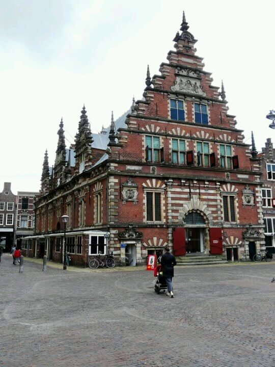 Historic building in Haarlem, Netherlands with striking architecture and bicycles parked outside.