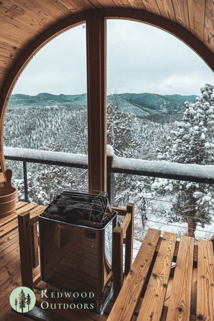 Cozy sauna with a scenic snowy mountain view through the window