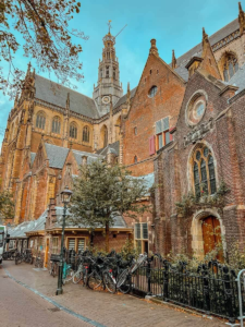 View of St. Bavo's Church in Haarlem, Netherlands with bicycles lined up in front of a charming street
