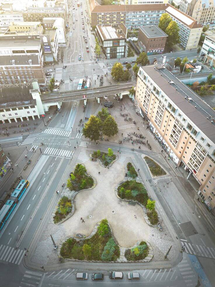 Aerial view of Nørrebro area in Copenhagen with roads, buildings, and green spaces.