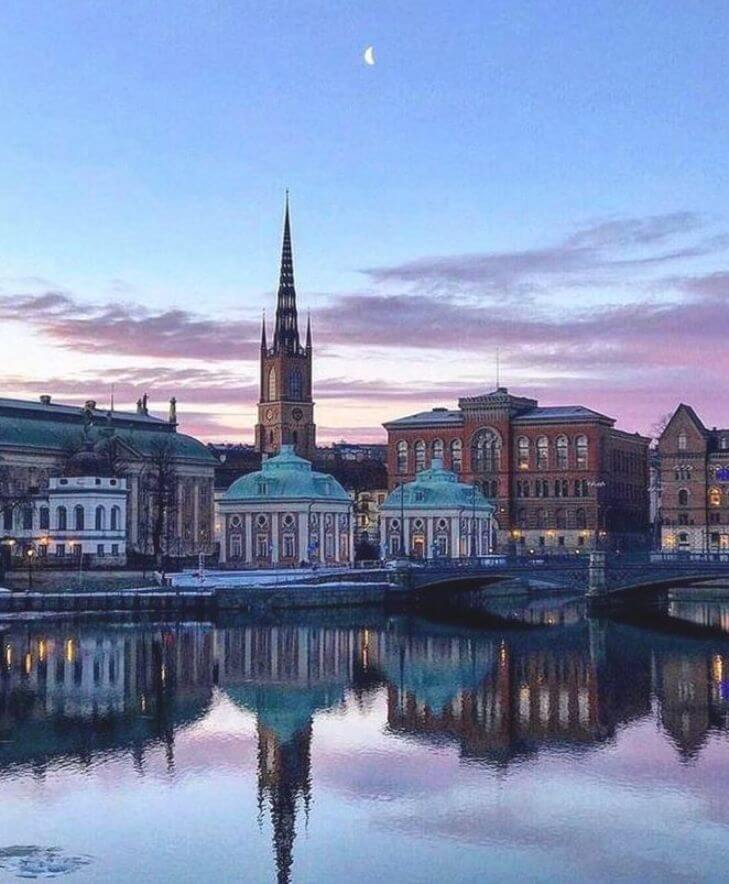 Twilight view of Gamla Stan and Riddarholmen, Stockholm, with reflections in water