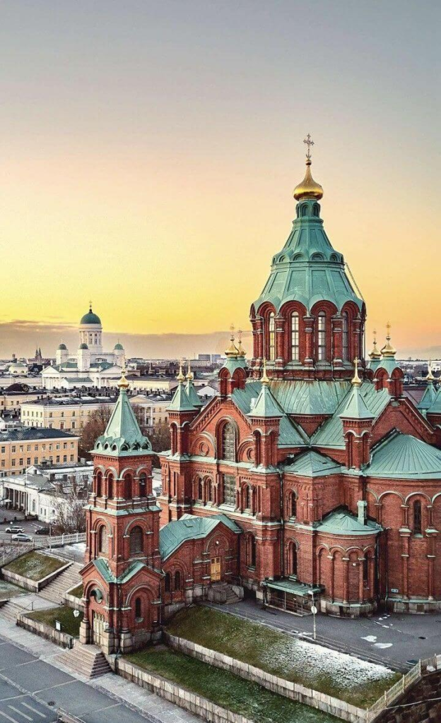 Sunset view of Helsinki with the Uspenski Cathedral overlooking the city skyline.