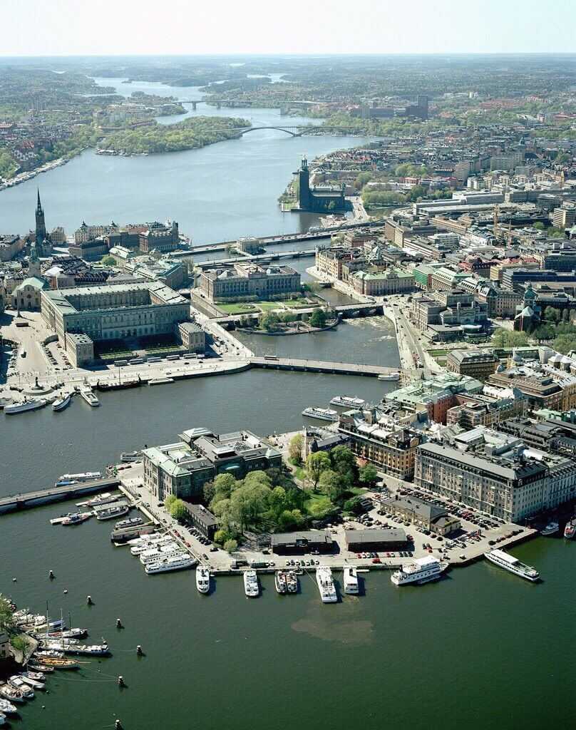 View of San Francisco’s iconic Golden Gate Bridge, cable car on steep hill, and bustling city streets