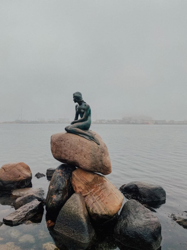 The Little Mermaid statue on a rock by the Copenhagen waterfront