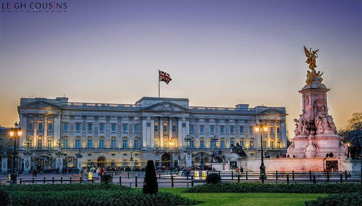Buckingham Palace in London at dusk with Victoria Memorial