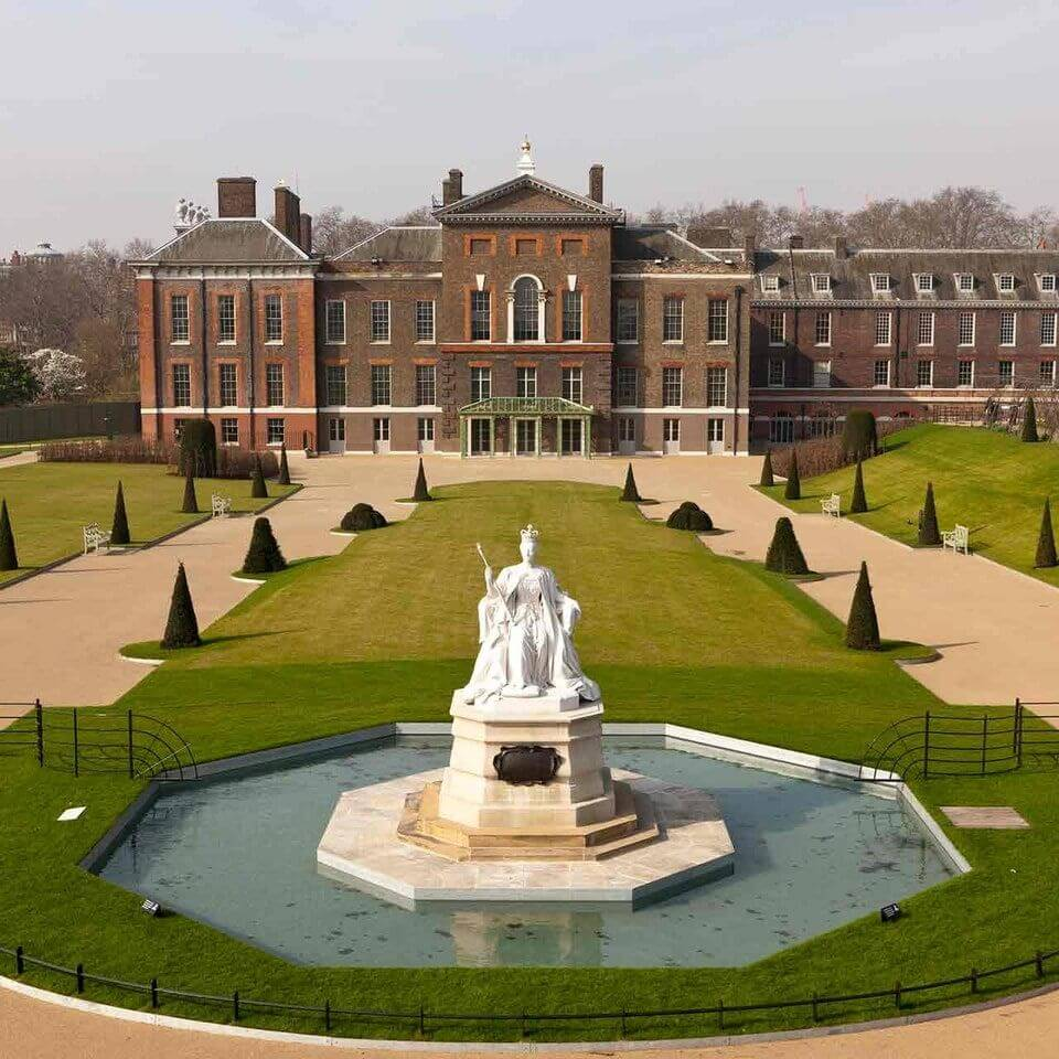 Kensington Palace in London with statue and formal gardens