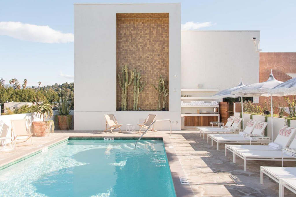 Modern California boutique hotel pool with minimalist design and loungers