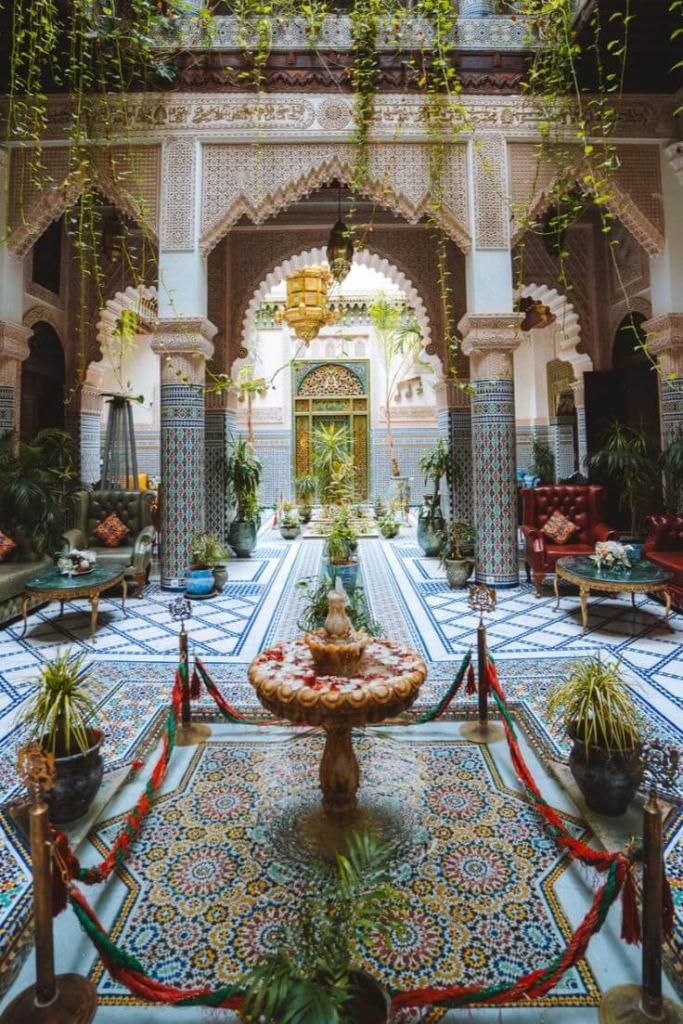 Traditional riad courtyard in Fes with mosaic tiles and fountain
