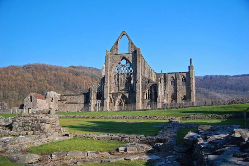 Tintern Abbey ruins in Wales surrounded by green countryside